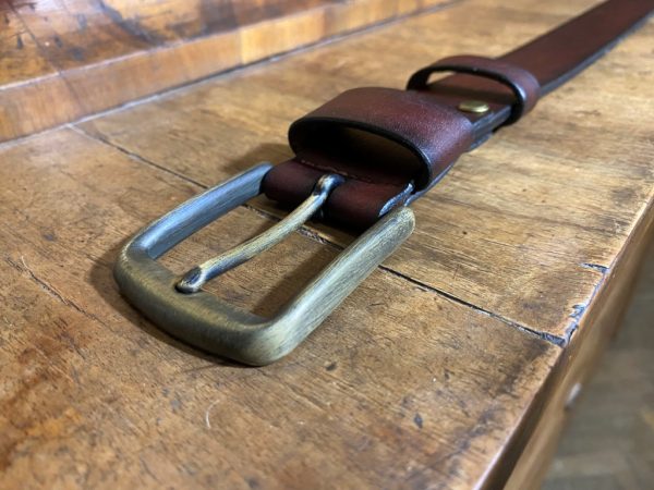 Leather belt with a patinated brass buckle